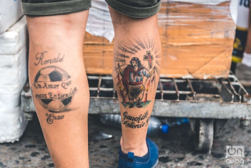 Sacred tattoos: On one leg a soccer ball and on the other El Gauchito Gil is a religious figure, object of popular devotion in Argentina.