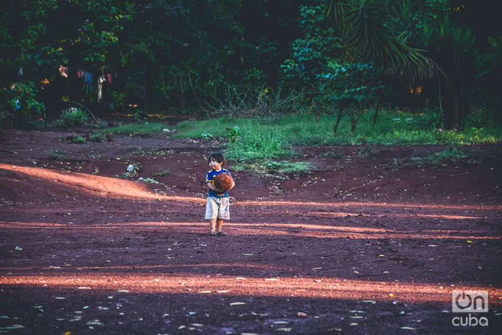 A boy with a soccer ball in the jungle of Misiones, Argentina.