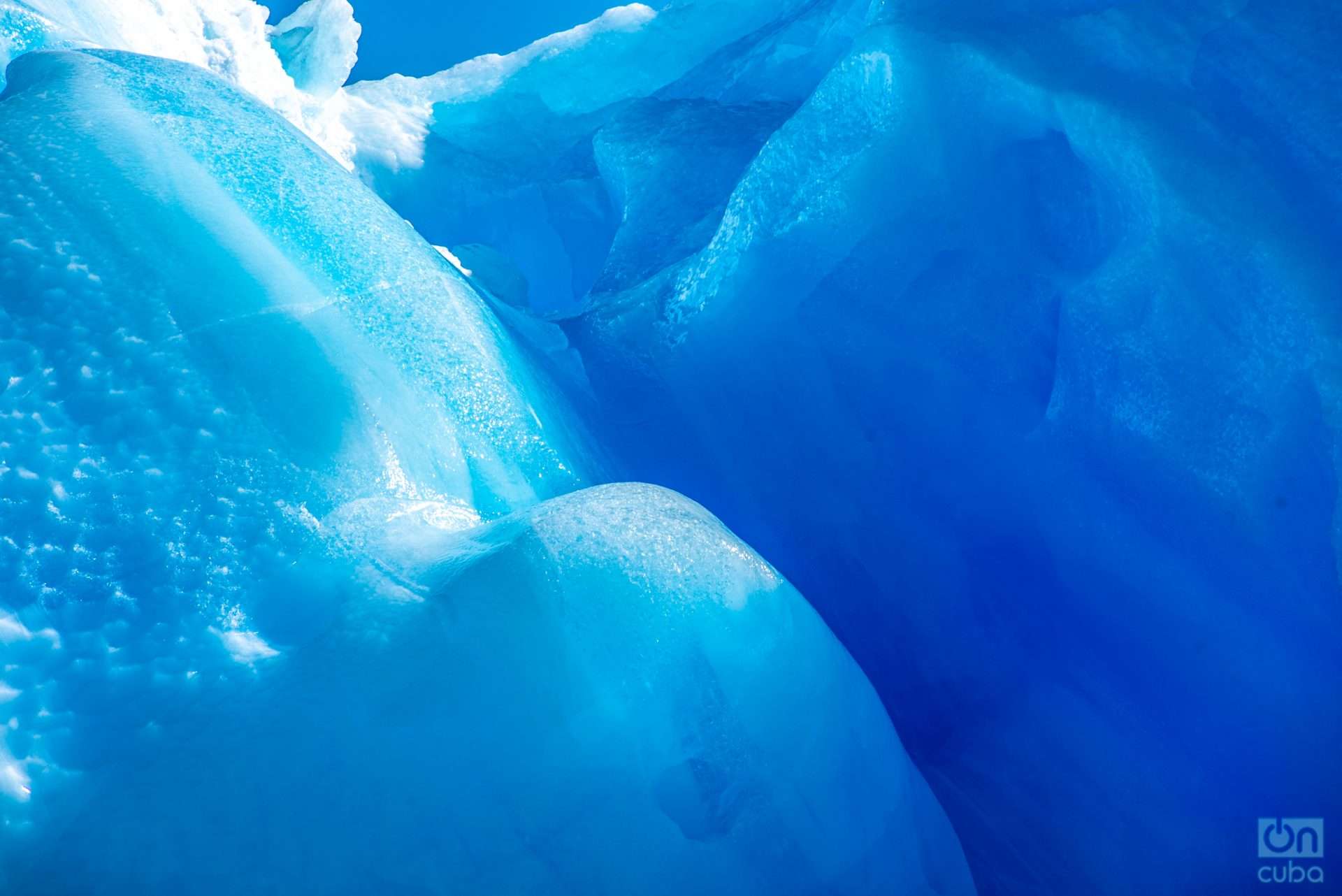 Pure ice is blue because it absorbs more red light and reflects blue light.