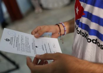 Un cubano observa la boleta electoral antes de ejercer su voto, en un colegio electoral de La Habana. Foto: Yander Zamora / EFE.