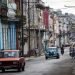 Personas y automóviles transitan por una calle de La Habana. Foto: Yander Zamora / EFE.