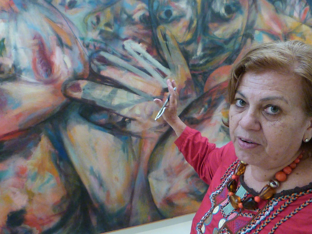 La curadora Teresa Toranzo, explica detalles de "Molote", 1966, óleo sobre tela. Foto: Ángel Marqués Dolz.