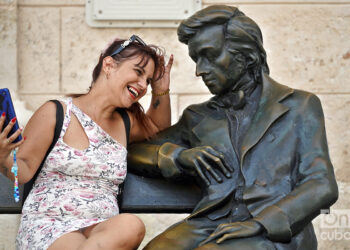 Una cubana parece ligar con el músico polaco Fréderic Chopin en la Plaza de San Francisco de Asis. Foto: Alejandro Ernesto.