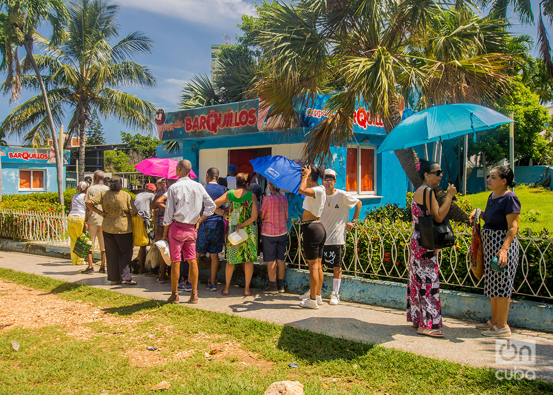 Personas hacen cola para comprar helado en las afueras del Coppelia, en el Vedado. Foto: Otmaro Rodríguez.