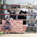 Un hombre descansa en el exterior de una vivienda en la región de San Antonio del Sur una semana después del paso de la tormenta tropical Oscar. Foto: Ernesto Mastrascusa / POOL / EFE.