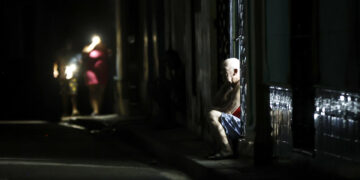 Personas de noche en una calle de La Habana durante durante el apagón por la desconexión total del sistema eléctrico de Cuba. Foto: Ernesto Mastrascusa / EFE.