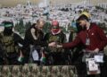 Militantes de Hamás y la Yihad Islámica se encuentran junto al rehén ruso-israelí Sasha (Alexander) Troufanov (d) y al rehén argentino-israelí Yair Horn (2i) antes de entregarlos al equipo de la Cruz Roja, en Khan Yunis. Foto: EFE/HAITHAM IMAD