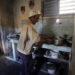 Un hombre en la cocina de su vivienda, en Cárdenas. Foto:  Ernesto Mastrascusa/EFE.