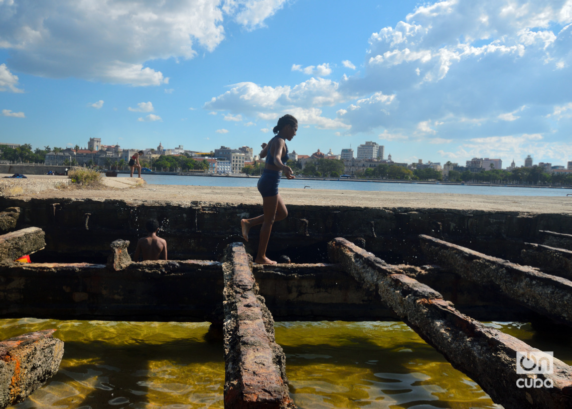 Una joven bañista en el antiguo Muelle del Carbón, en Casablanca. Al fondo se puede ver La Habana. Foto: Otmaro Rodríguez.