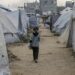 Una niña desplazada camina entre las tiendas de un campo de refugiados en Jabalia, norte de la Franja de Gaza, el 2 de mayo de 2025. Foto: EFE/EPA/MOHAMMED SABER.