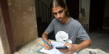 Un joven cubano estudia usando la conexión a internet en su teléfono móvil, tras el anuncio de las nuevas tarifas de Etecsa. Foto: Otmaro Rodríguez.