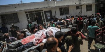 Palestinos cargan el cuerpo de un hombre asesinado a tiros por el Ejército de Israel en un punto de distribución de alimentos en Gaza, el 20 de julio de 2025. Foto: Mohammed Saber / EFE / EPA.