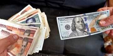 Imagen que simula una transacción en el mercado informal de divisas en Cuba, en el que el dólar ha mantenido un ascenso progresivo a lo largo de 2025 hasta superar los 400 pesos de valor. Foto: Ernesto Mastrascusa / EFE.