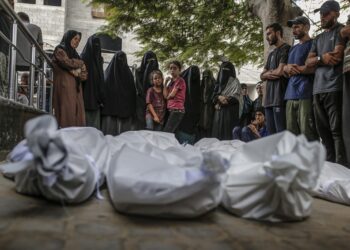 Palestinos rezan junto a los cuerpos cubiertos de familiares muertos por ataques de Israel, en el hospital Al Shifa de la ciudad de Gaza. Foto: Mohammed Saber / EFE / EPA.