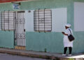 Una enfermera espera fuera de un consultorio médico en el poblado de Perico, Matanzas, uno de los epicentros de los casos de chikunguña recientemente. Foto: EFE/ Ernesto Mastrascusa.