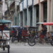 Bicitaxis transitan por una calle este martes, en La Habana. Foto:  Ernesto Mastrascusa/EFE.