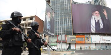 Fuerzas de seguridad iraníes vigilan la enorme valla publicitaria del líder supremo iraní, el ayatolá Alí Jamenei, en la plaza Valiasr de Teherán, este 2 de marzo de 2026. Foto: ABEDIN TAHERKENAREH /EFE/EPA.