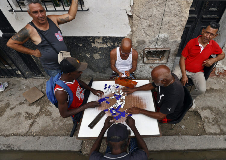 Personas juegan dominó durante un apagón en La Habana. Foto:  Ernesto Mastrascusa/EFE.