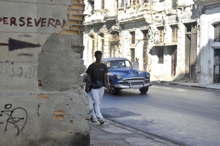 Una persona camina por una calle habanera. Foto: Ernesto Mastrascusa/EFE.