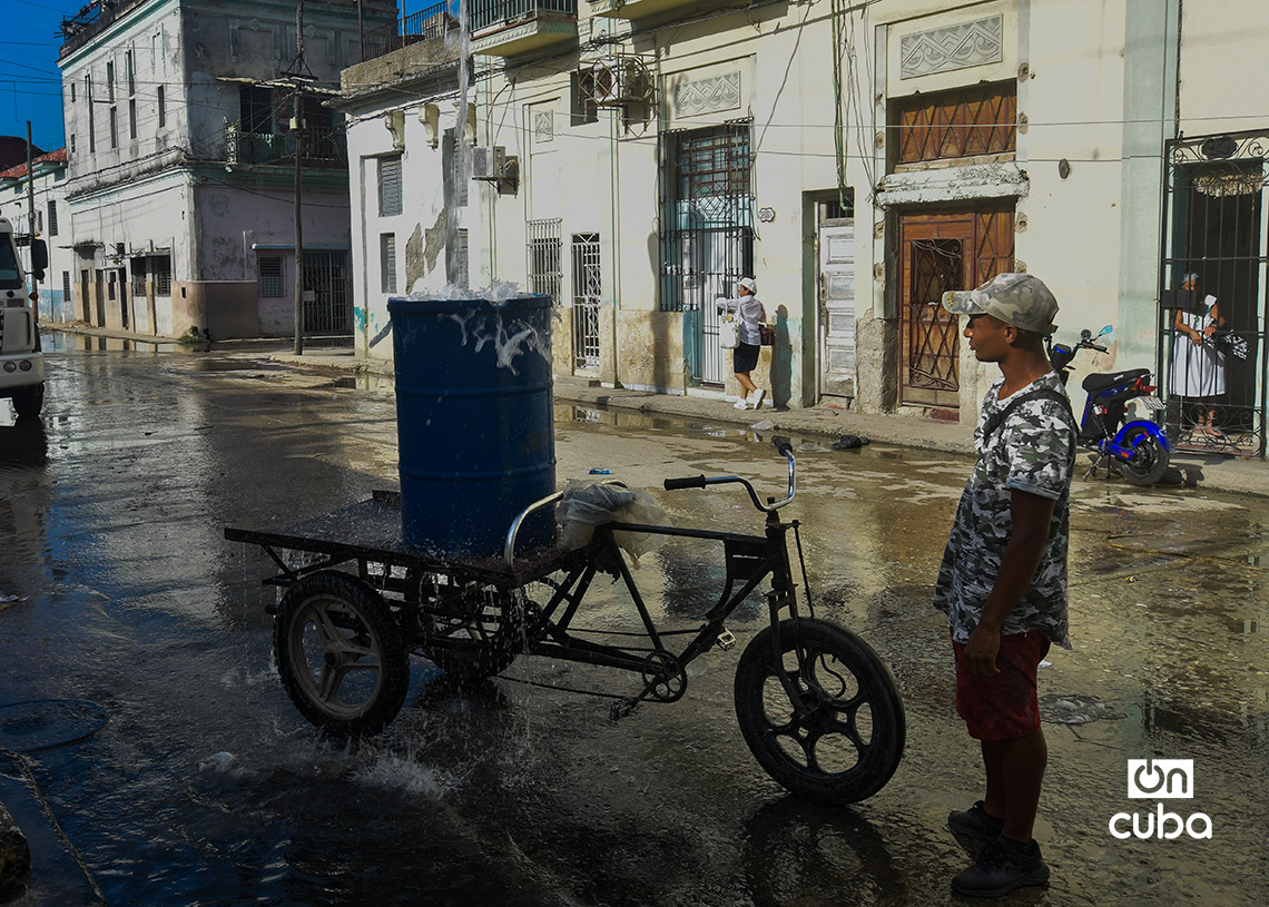 Unas personas cargan agua para sus viviendas y otras lo hacen para vender la carga, como modo de subsistencia. Foto: Otmaro Rodríguez.