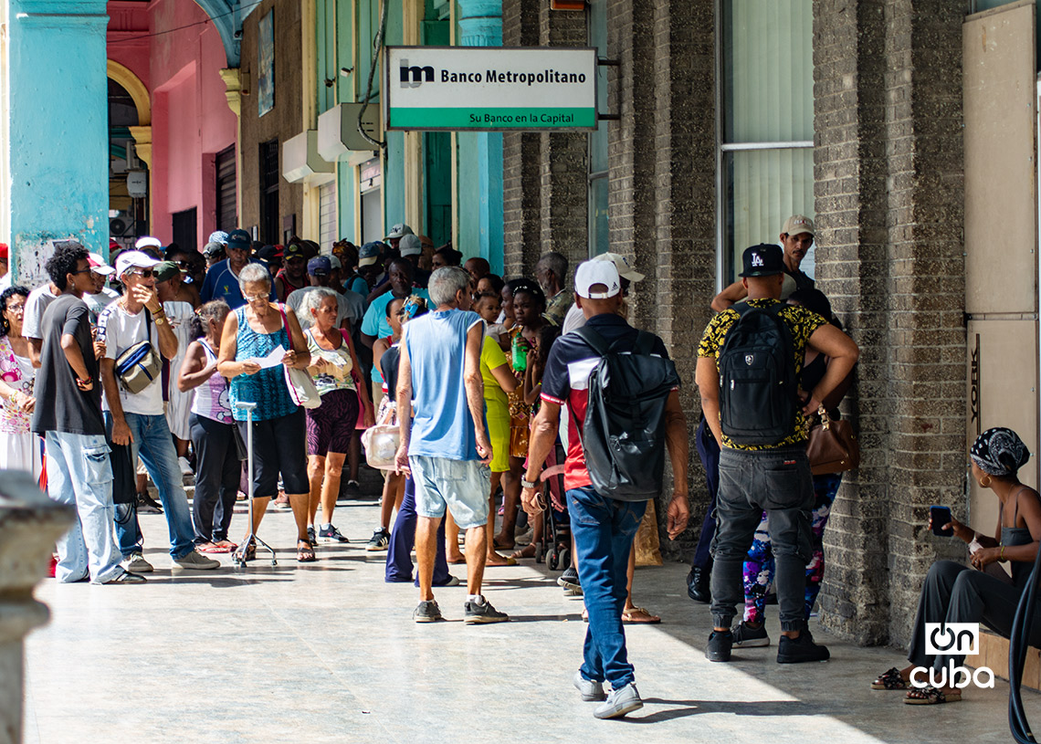 Jubilados y otras personas hacen cola en un banco en La Habana. Foto: Otmaro Rodríguez.