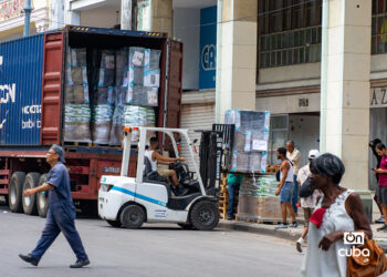 Trabajadores descargando mercancía en una tienda en la calle Galiano, en La Habana. Foto: Otmaro Rodríguez.