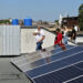 Presidente de JOLYNI S.U.R.L, Jorge Félix Peraza Noriega, caminando junto a paneles fotovoltaicos en La Habana. Foto:  Ernesto Mastrascusa/EFE.