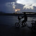 Un bicitaxi transita por el Malecón habanero durante un apagón en La Habana. Foto: Ernesto Mastrascusa / EFE.