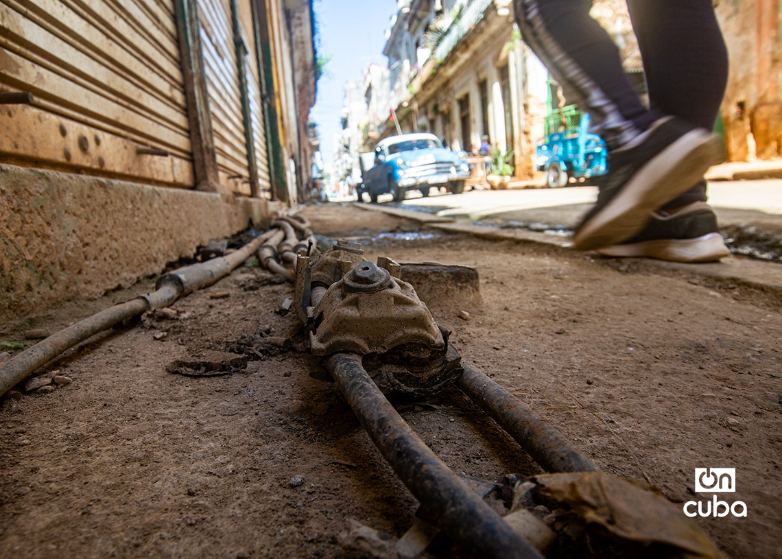 Cables soterrados al descubierto en una acera en La Habana. Foto: Otmaro Rodríguez.